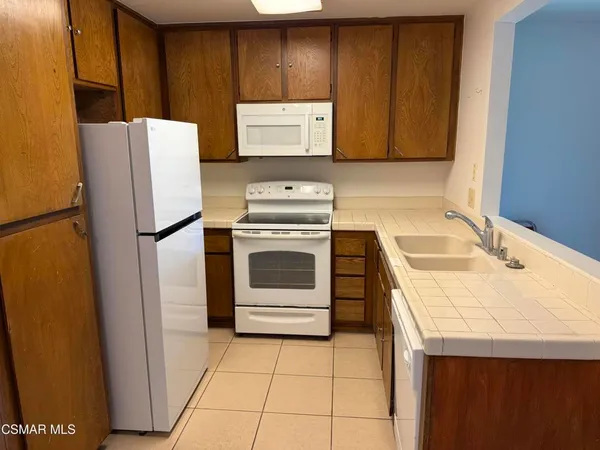a kitchen with a stove sink and refrigerator