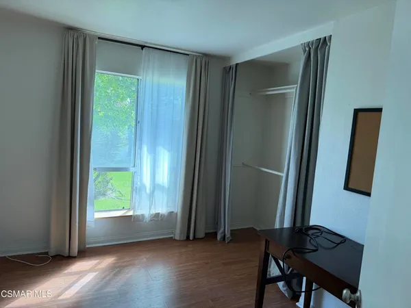 a view of room with a window and wooden floor
