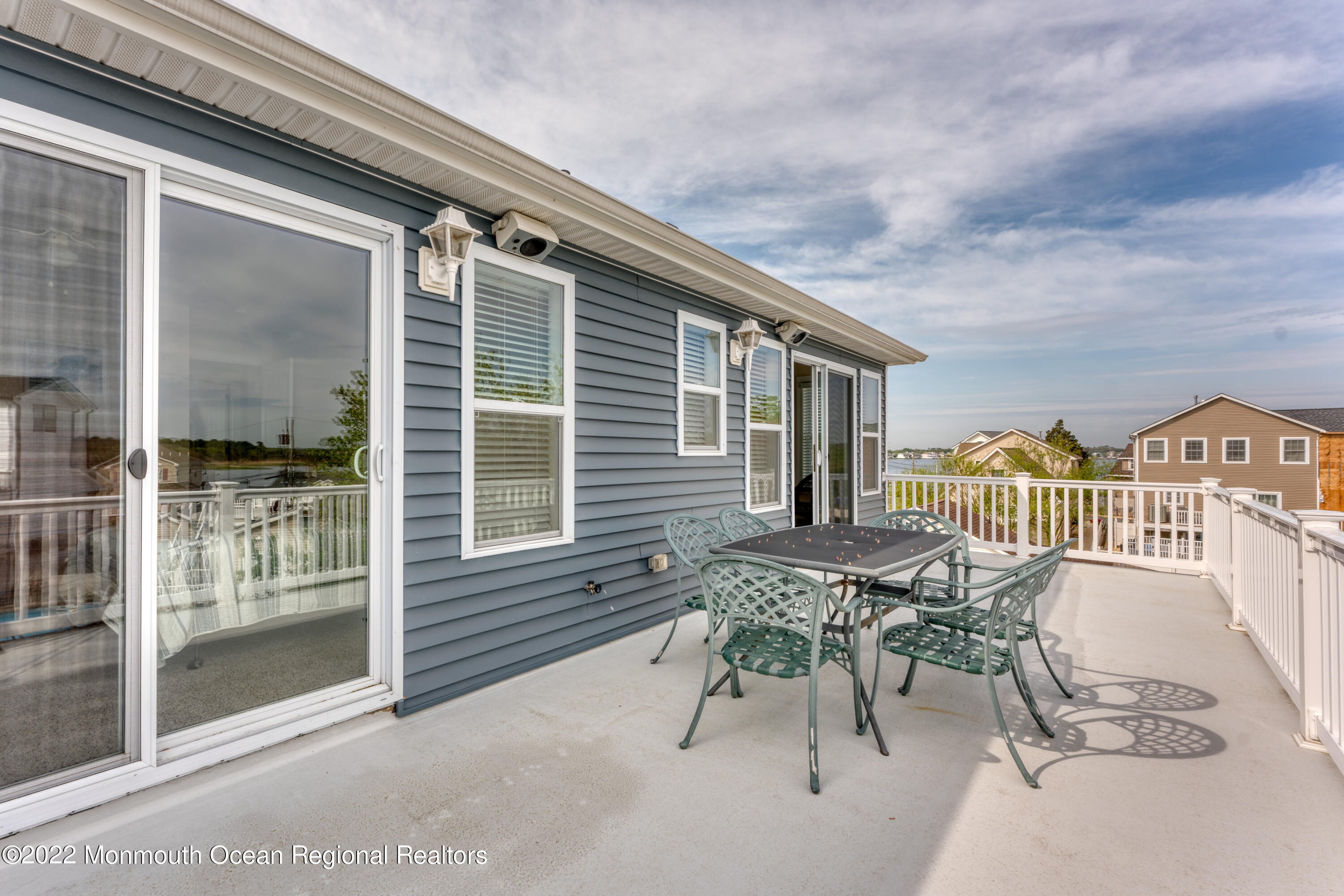 122 Mathis Drive Brick, NJ 08723 - Photo 25 of 35 a patio with table and chairs and potted plants
