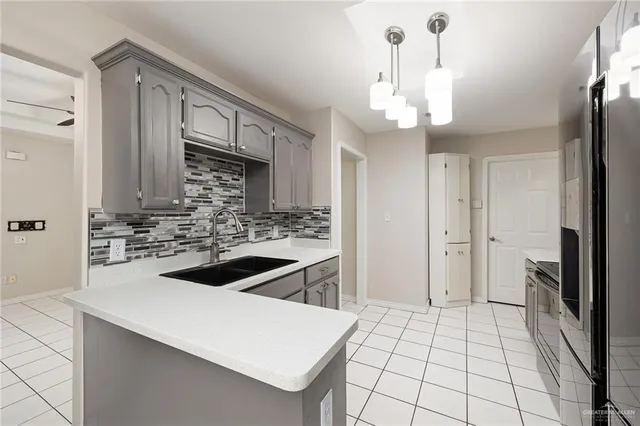 a kitchen with a sink stove and refrigerator