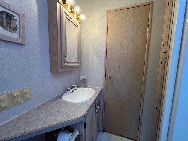 2795 East 28th Road Marseilles, IL 61341 - Photo 20 of 65 a bathroom with a granite countertop sink and a mirror