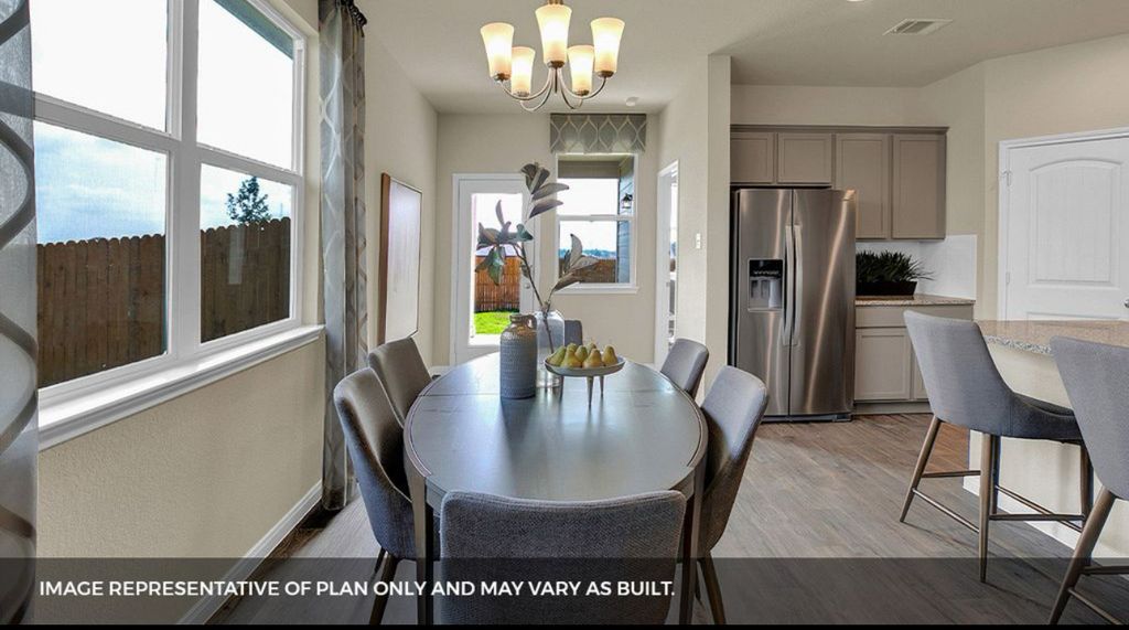 156 Docile Loop San Marcos, TX 78666 - Photo 13 of 40 An open-concept living space presents a well-appointed kitchen and an inviting dining area.