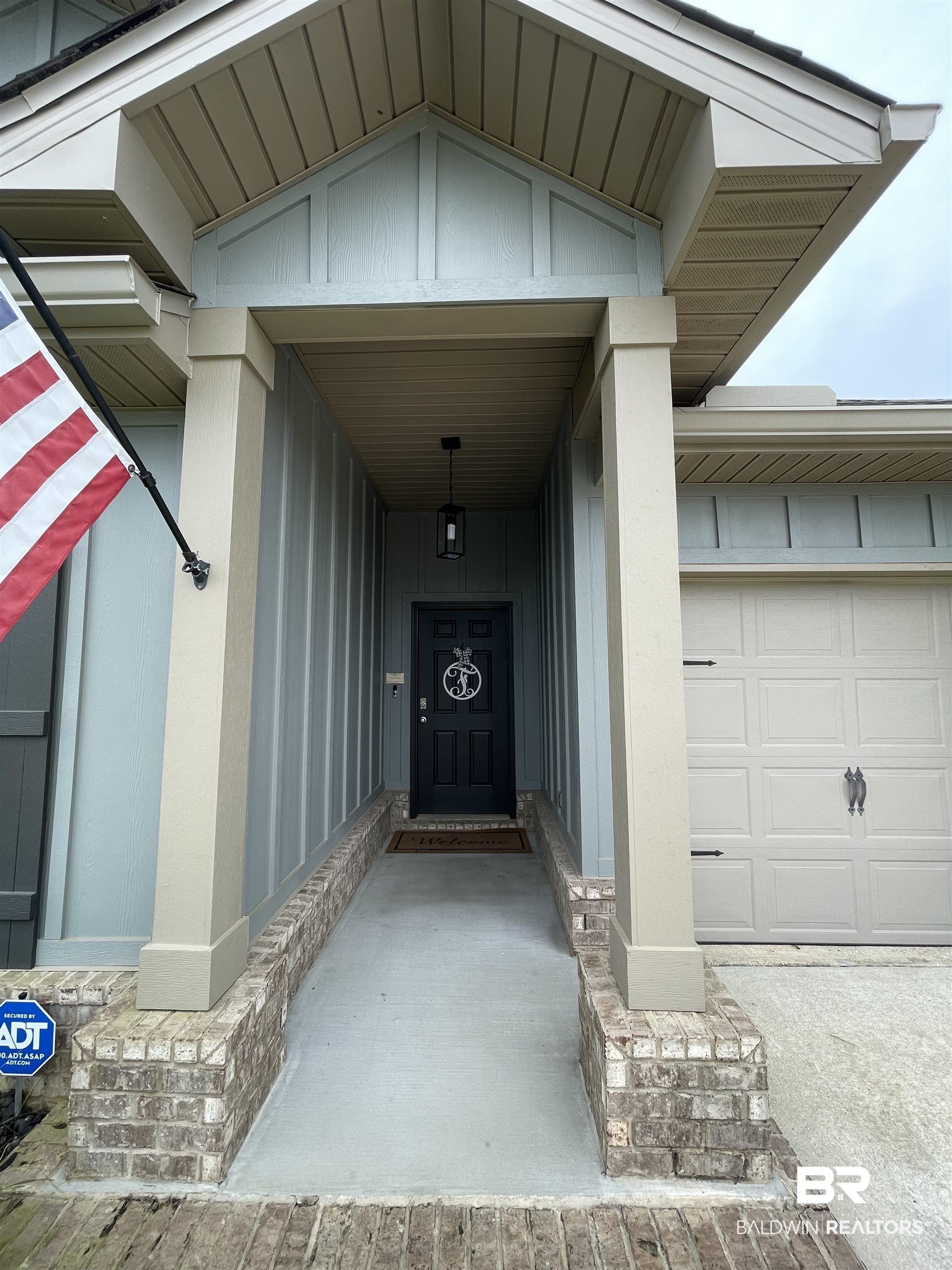 8621 Bronze Lane Foley, AL 36535 - Photo 2 of 13 View of exterior entry with a garage