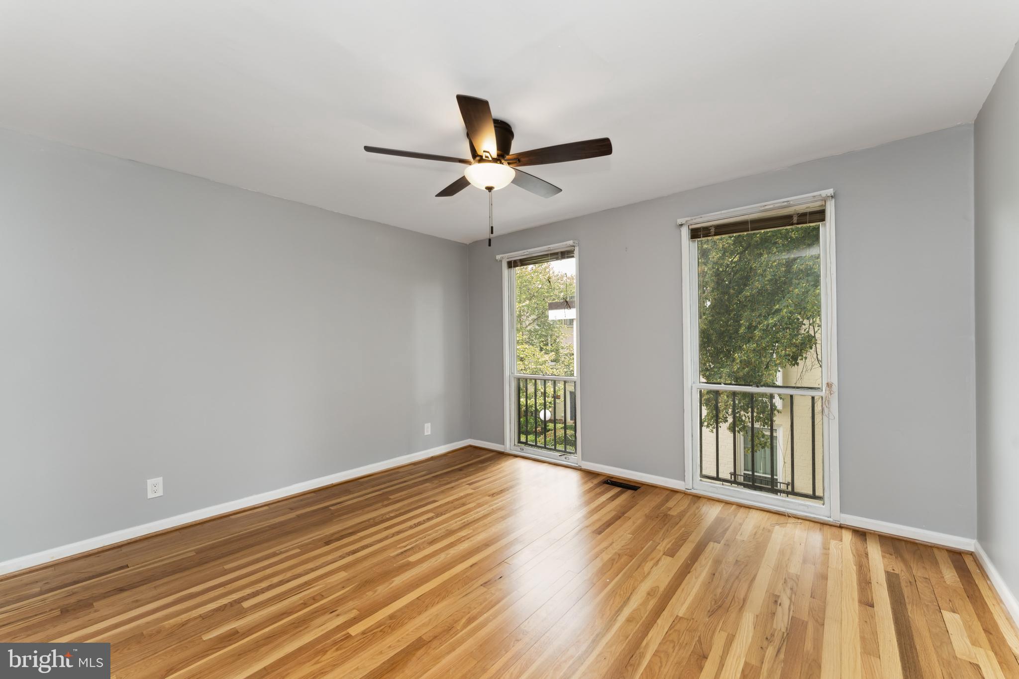 212 G Street Southwest, Unit 212 Washington, DC 20024 - Photo 14 of 17 wooden floor in an empty room with a window