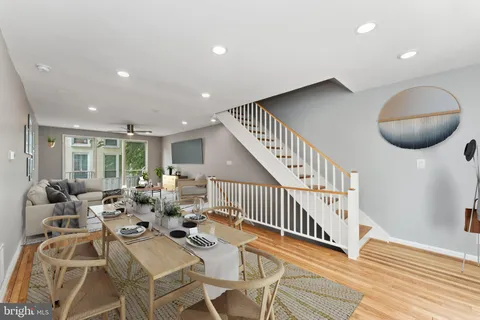 a view of a dining room with furniture wooden floor and chandelier