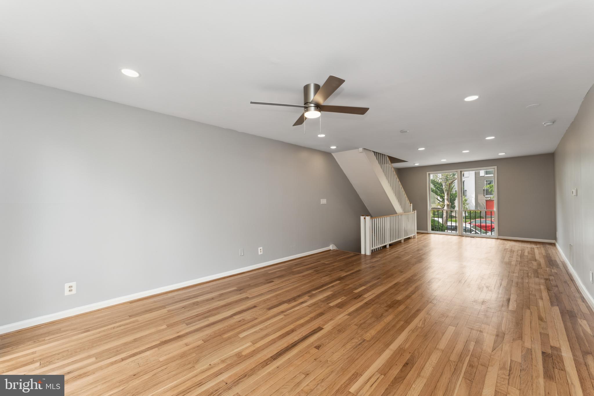 212 G Street Southwest, Unit 212 Washington, DC 20024 - Photo 4 of 17 wooden floor in an empty room with a window