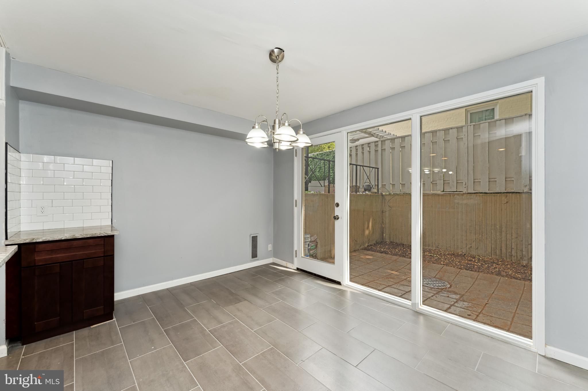 212 G Street Southwest, Unit 212 Washington, DC 20024 - Photo 7 of 17 a view of an empty room with a glass door