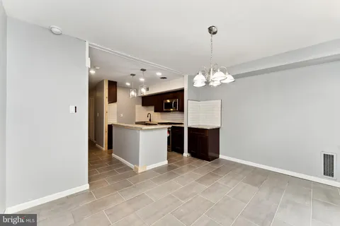 a view of a kitchen with a sink and refrigerator