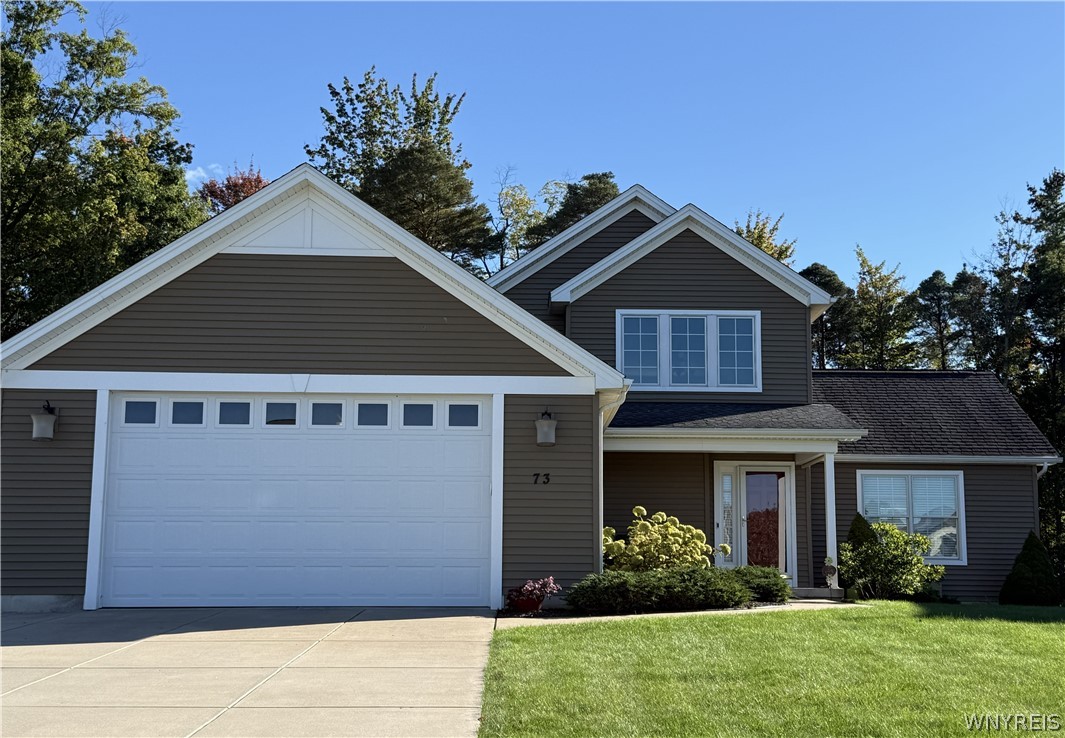 73 Chestnut Lancaster, NY 14086 - Photo 1 of 41 Gabled rooflines and a concrete driveway define this modern suburban facade.