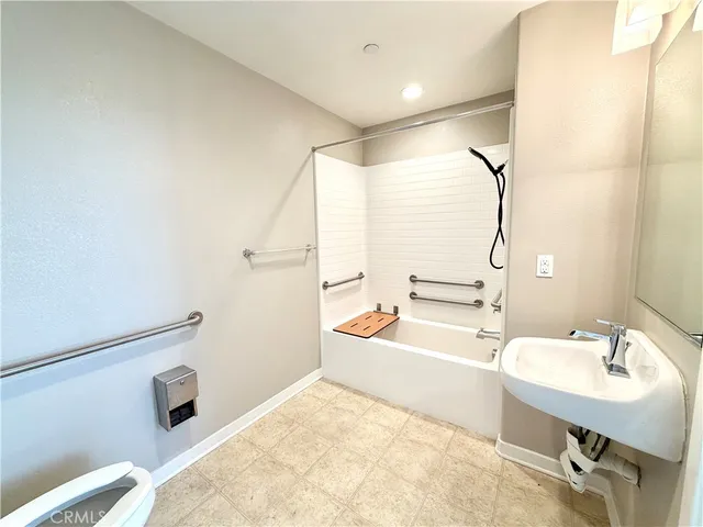 a bathroom with a sink toilet tub and shower