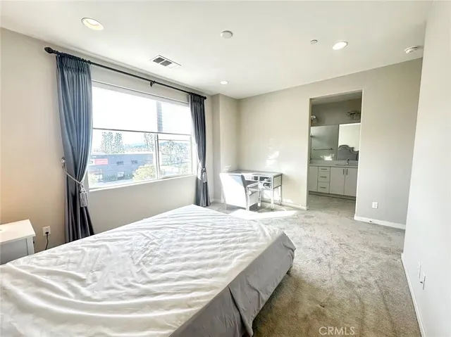 a spacious bathroom with a double vanity sink mirror and shower