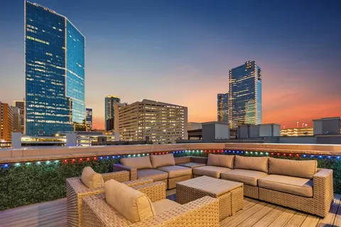 a view of roof deck with seating space and city view
