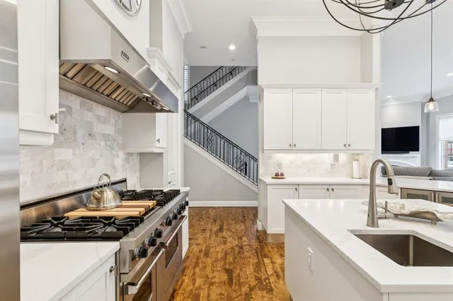 a kitchen that has a sink and a stove