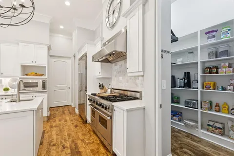 a kitchen with stainless steel appliances granite countertop a stove and a refrigerator