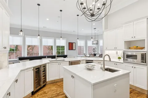a kitchen with a sink a stove and cabinets