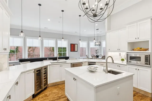 a kitchen with a sink a stove and cabinets