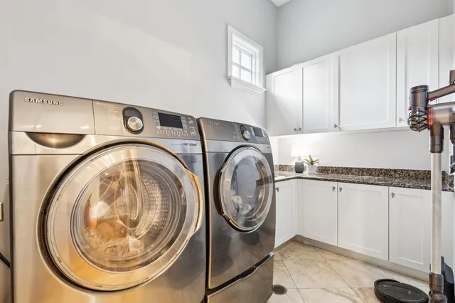 a view of a hallway with white walls and stairs