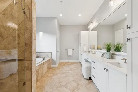 a spacious bathroom with a double vanity sink mirror and double