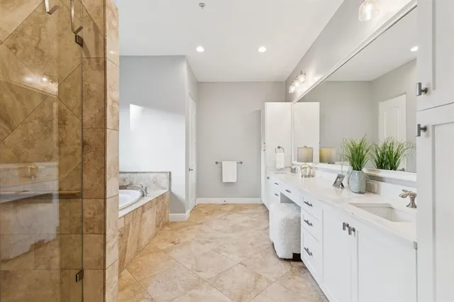 a spacious bathroom with a double vanity sink mirror and double