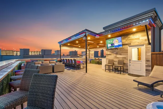 a balcony with hardwood floor and outdoor seating