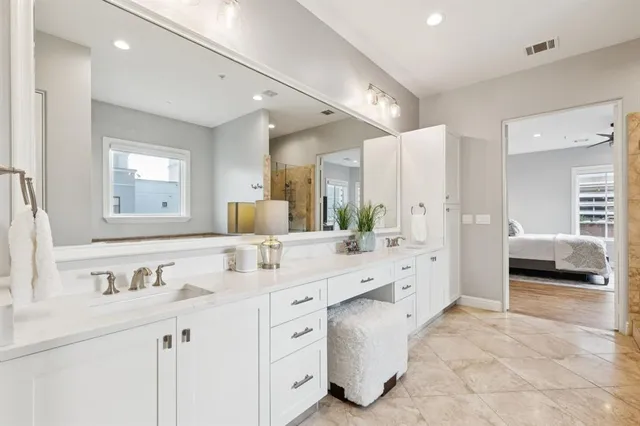 a room with stainless steel appliances kitchen island granite countertop furniture and a rug