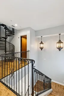 a kitchen with lots of counter and chairs