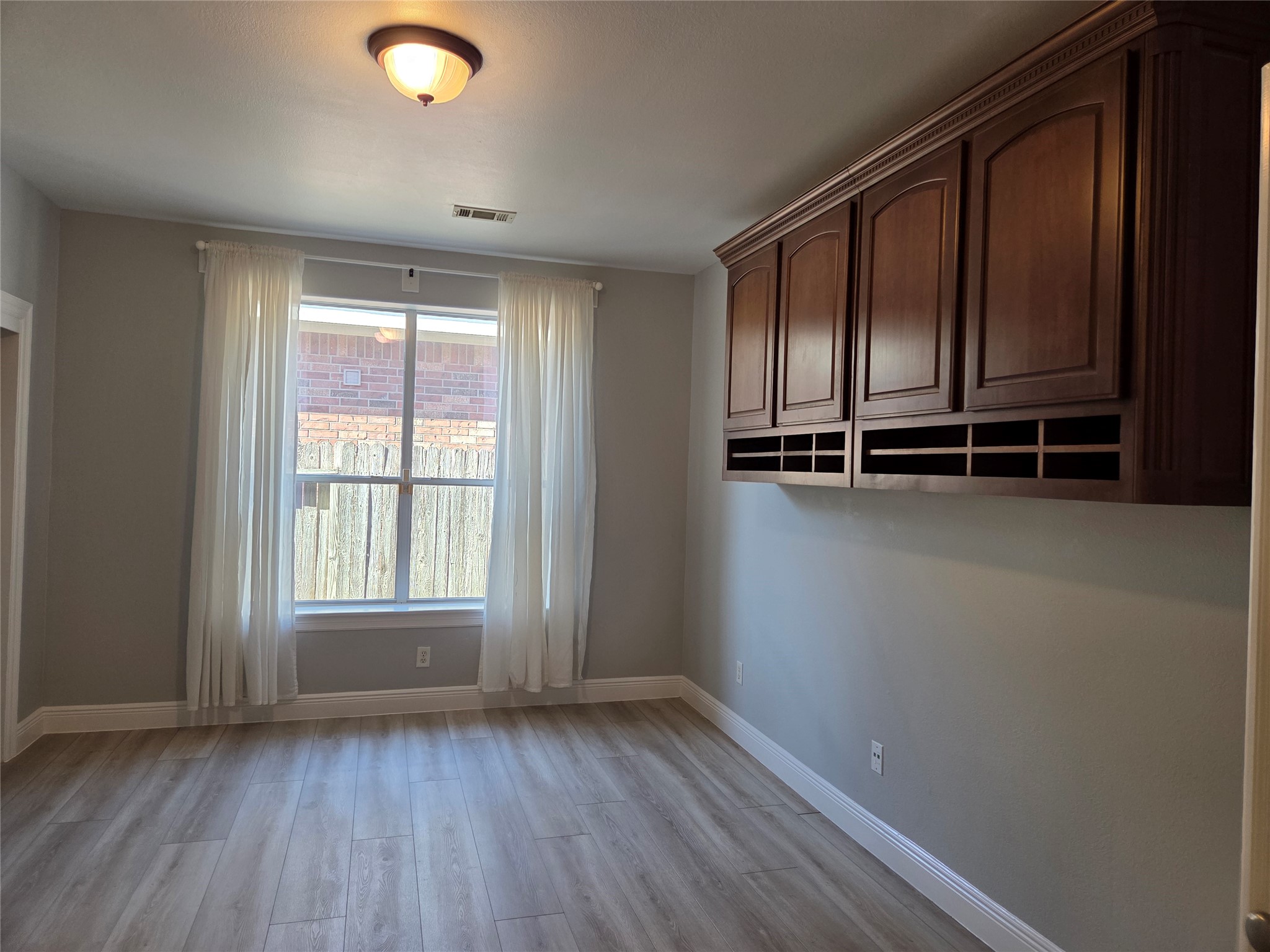4607 Wild Bluebonnet Way Houston, TX 77084 - Photo 12 of 18 an empty room with wooden floor and windows