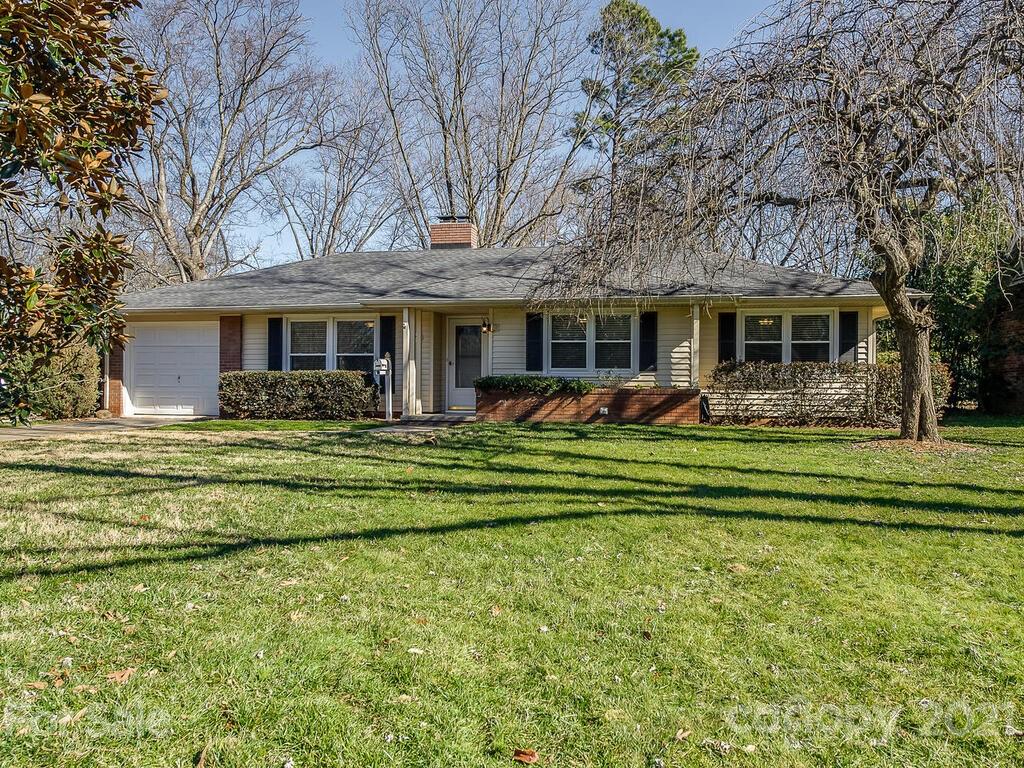 5223 Seacroft Road Charlotte, NC 28210 - Photo 1 of 23 a front view of a house with a garden and trees