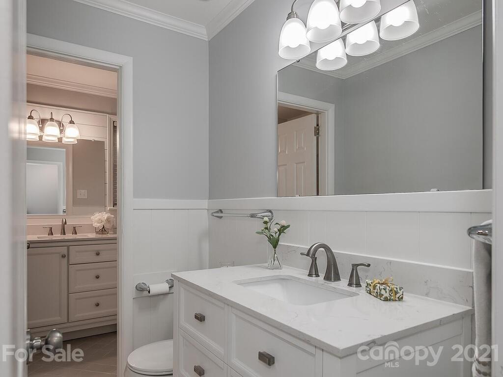 5223 Seacroft Road Charlotte, NC 28210 - Photo 12 of 23 a bathroom with a sink a toilet and a mirror
