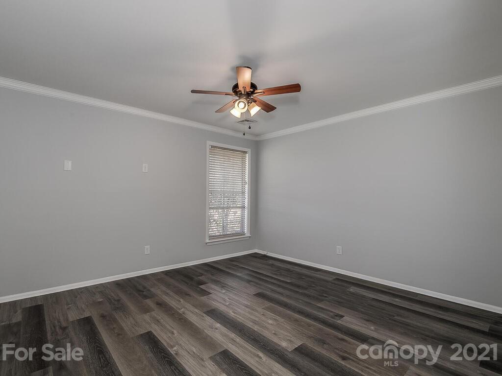 5223 Seacroft Road Charlotte, NC 28210 - Photo 13 of 23 wooden floor in an empty room with a window