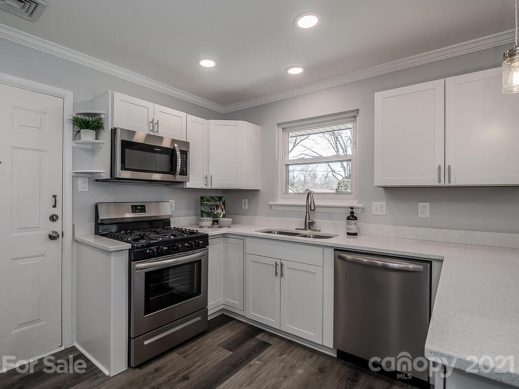5223 Seacroft Road Charlotte, NC 28210 - Photo 9 of 23 a kitchen with a sink stove and microwave