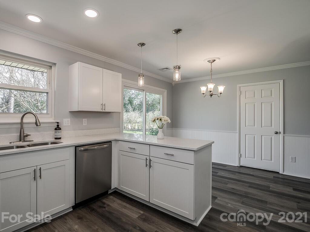 5223 Seacroft Road Charlotte, NC 28210 - Photo 10 of 23 a kitchen with a sink cabinets and wooden floor