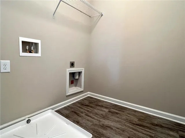 a view of a room with wooden floor and white walls