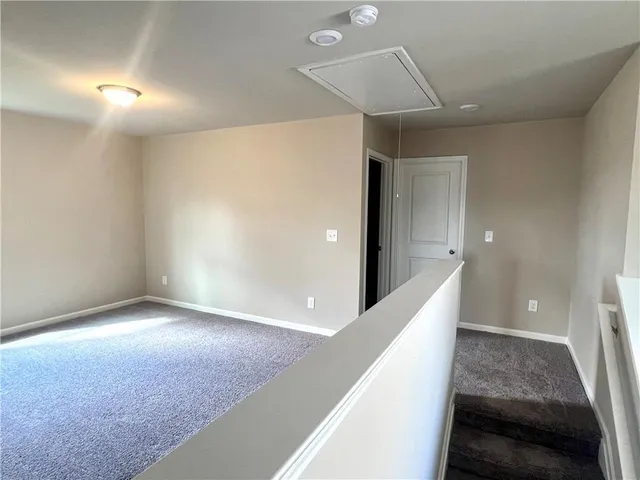 a large kitchen with stainless steel appliances a large counter top a stove and a refrigerator