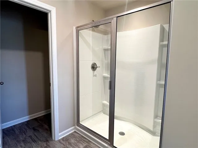 a bathroom with a glass shower door