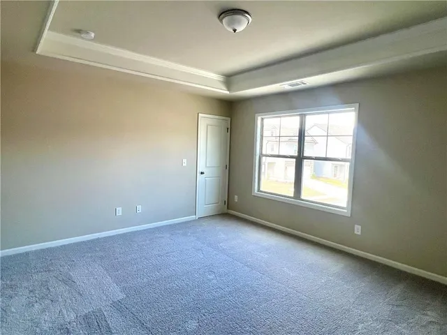 an empty room with a empty space and windows
