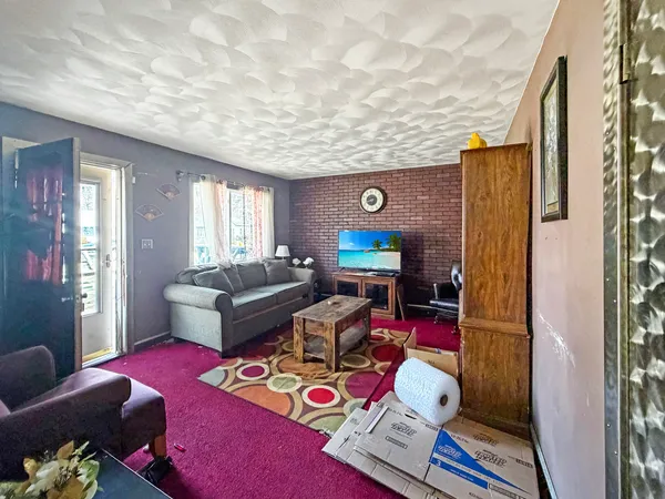a living room with furniture and a floor to ceiling window