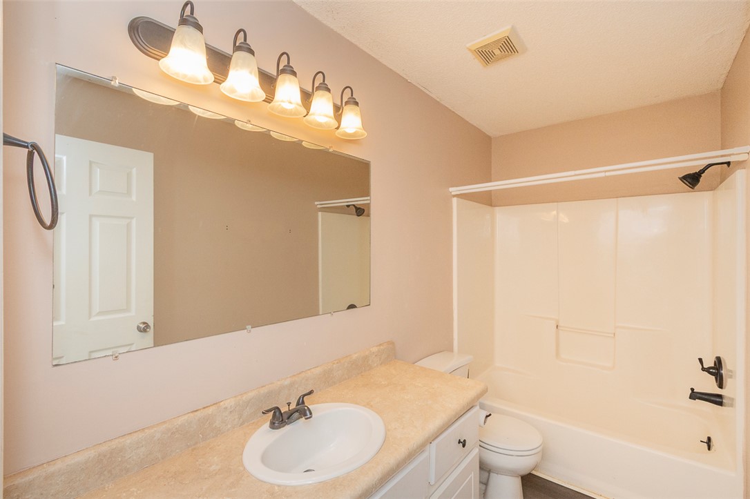 1118 Gilreath Road Anderson, SC 29621 - Photo 12 of 18 This functional bathroom features a shower-tub combination, practical vanity, and large mirror, creating a neat and inviting space.