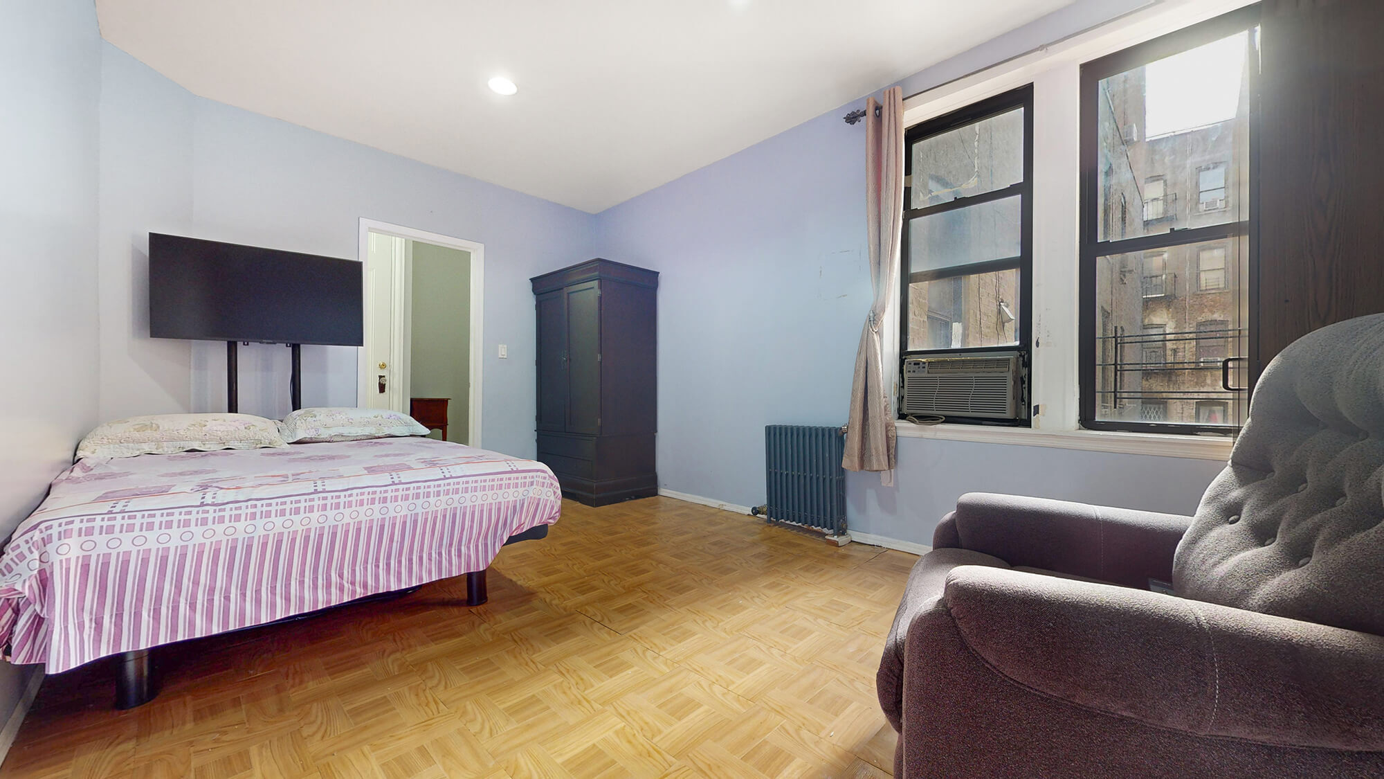 Undisclosed Address Manhattan, NY 10031 - Photo 10 of 13 a bedroom with a bed couch and a large window