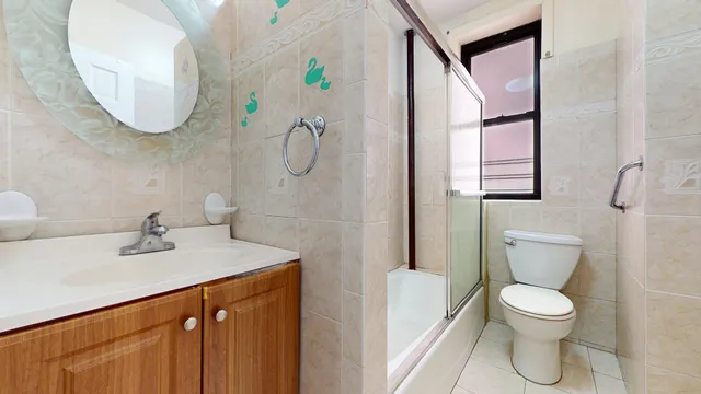 a bathroom with a sink a toilet and a mirror