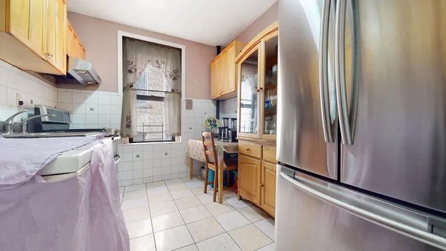 a kitchen with stainless steel appliances granite countertop a refrigerator and a stove