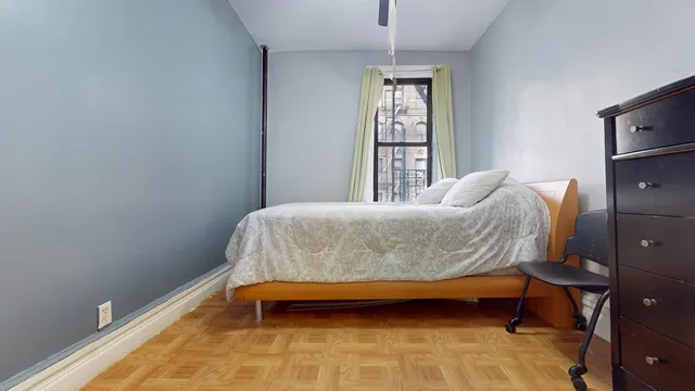 a bedroom with a bed and a window