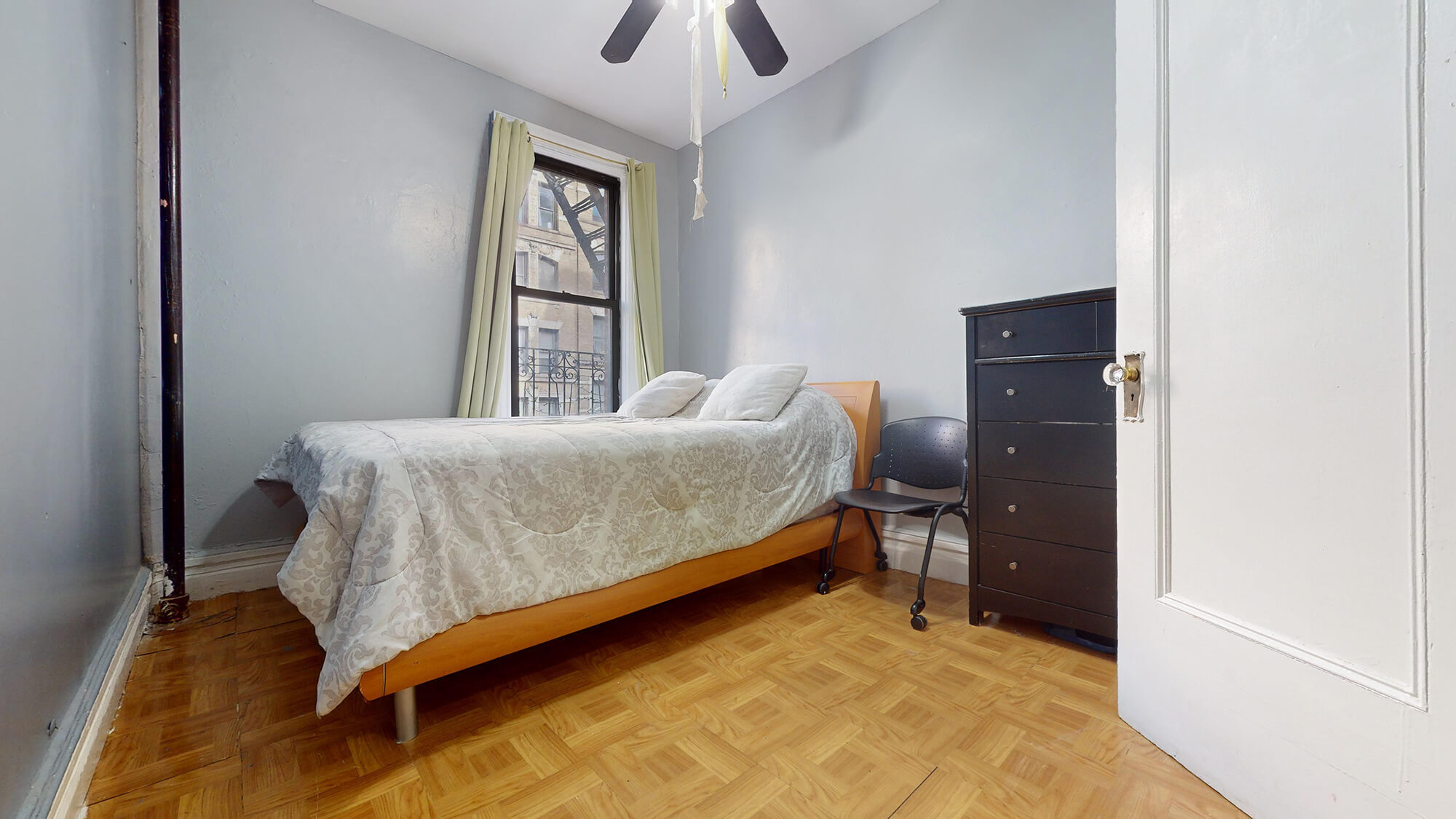 Undisclosed Address Manhattan, NY 10031 - Photo 9 of 13 a bedroom with a bed and a chandelier