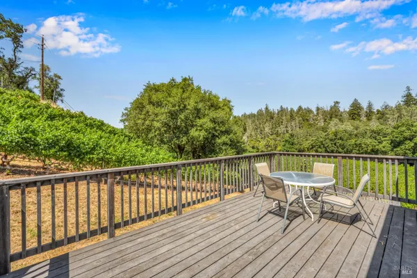 a view of a balcony with wooden floor and outdoor seating