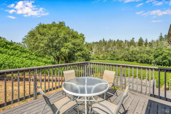 a view of a chair and table in the balcony