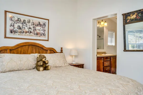 a bedroom with a bed and a painting on the wall