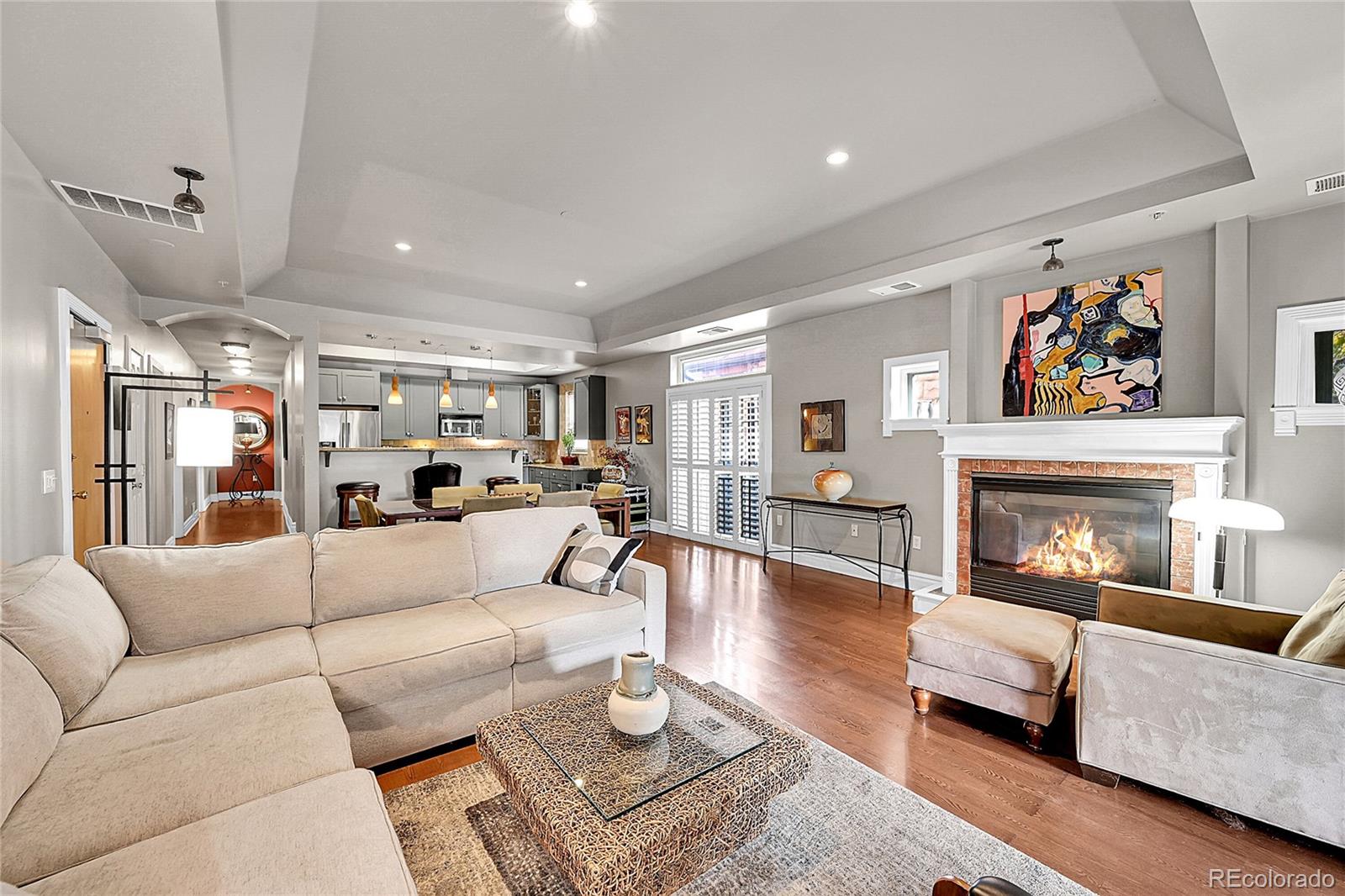 1352 Pennsylvania Street, Unit 2 Denver, CO 80203 - Photo 12 of 45 a living room with furniture and a fireplace