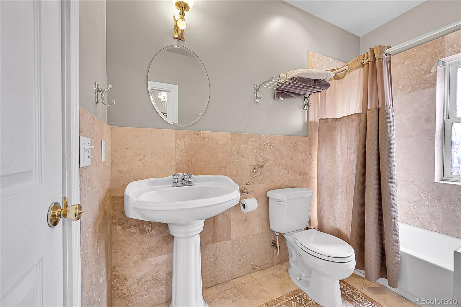 1352 Pennsylvania Street, Unit 2 Denver, CO 80203 - Photo 27 of 45 a bathroom with a sink toilet and shower