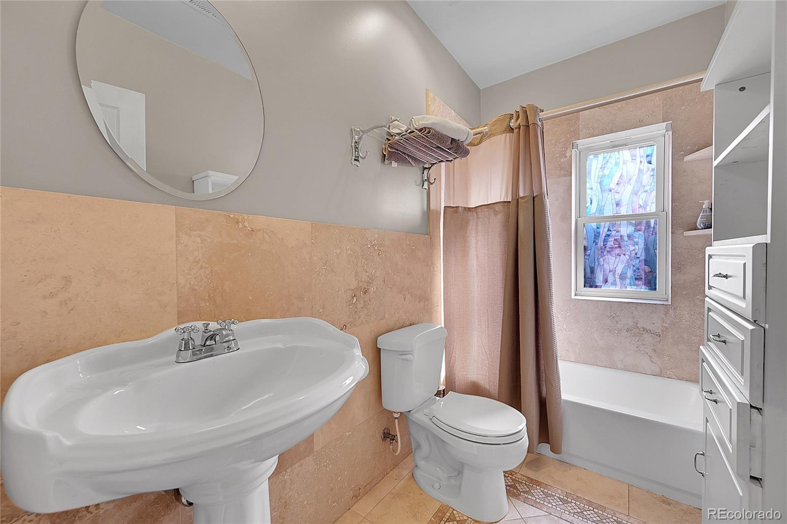 1352 Pennsylvania Street, Unit 2 Denver, CO 80203 - Photo 28 of 45 a white toilet sitting next to a bathroom sink