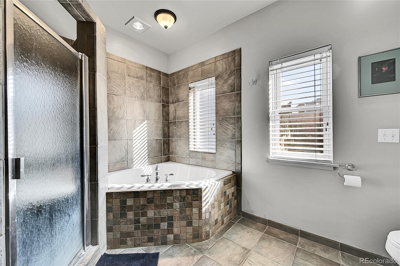 1352 Pennsylvania Street, Unit 2 Denver, CO 80203 - Photo 36 of 45 a bathroom with a tub sink and mirror